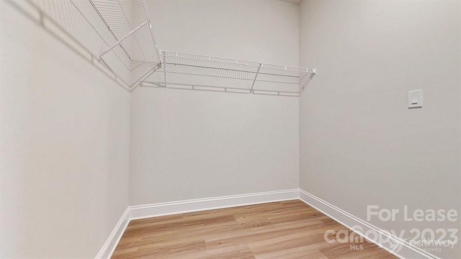 163 Tanner Loop Troutman, NC 28166 - Photo 22 of 27 a view of a room with racks on the wall