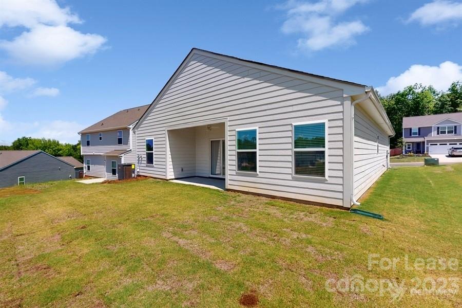 163 Tanner Loop Troutman, NC 28166 - Photo 25 of 27 a view of a house with a backyard