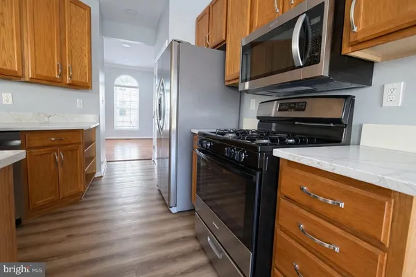 a kitchen with stainless steel appliances granite countertop a stove and a microwave
