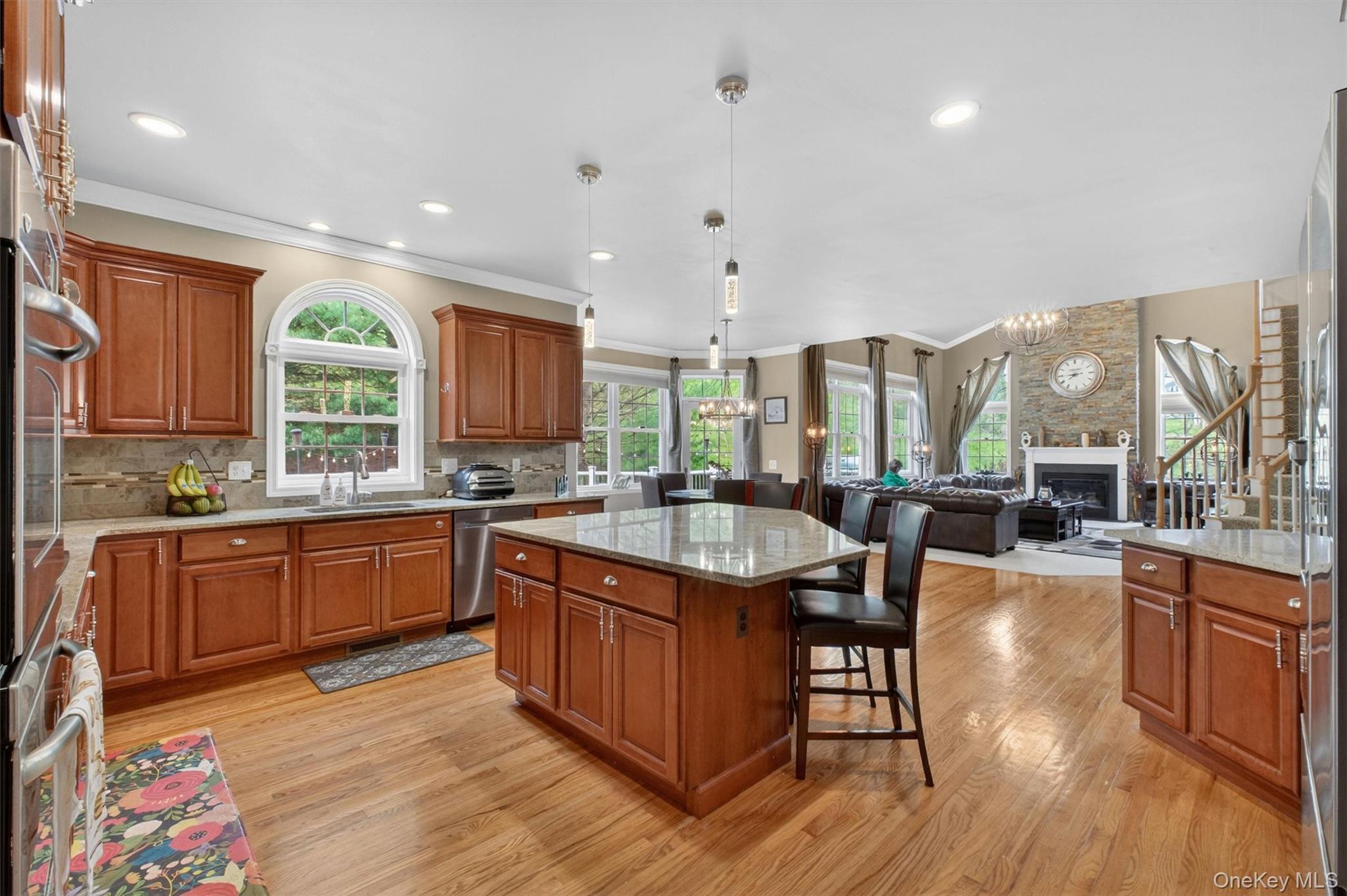 219 Country Club Road Hopewell Junction, NY 12533 - Photo 11 of 49 a kitchen with stainless steel appliances granite countertop a stove a sink dishwasher and a refrigerator with wooden floor