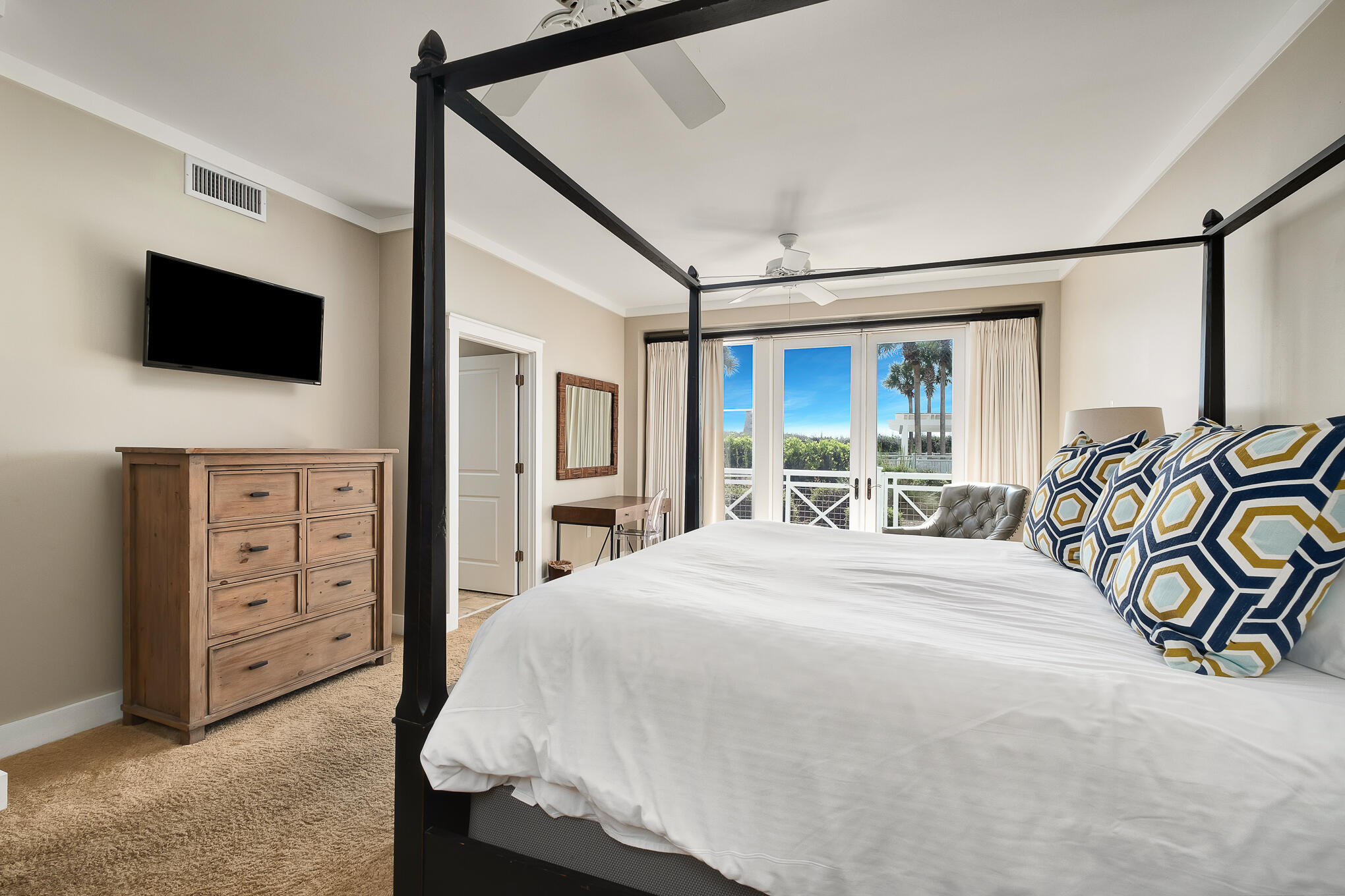 337 Bridge Lane, Unit 103B Inlet Beach, FL 32461 - Photo 17 of 37 a spacious bedroom with a bed and a flat screen tv