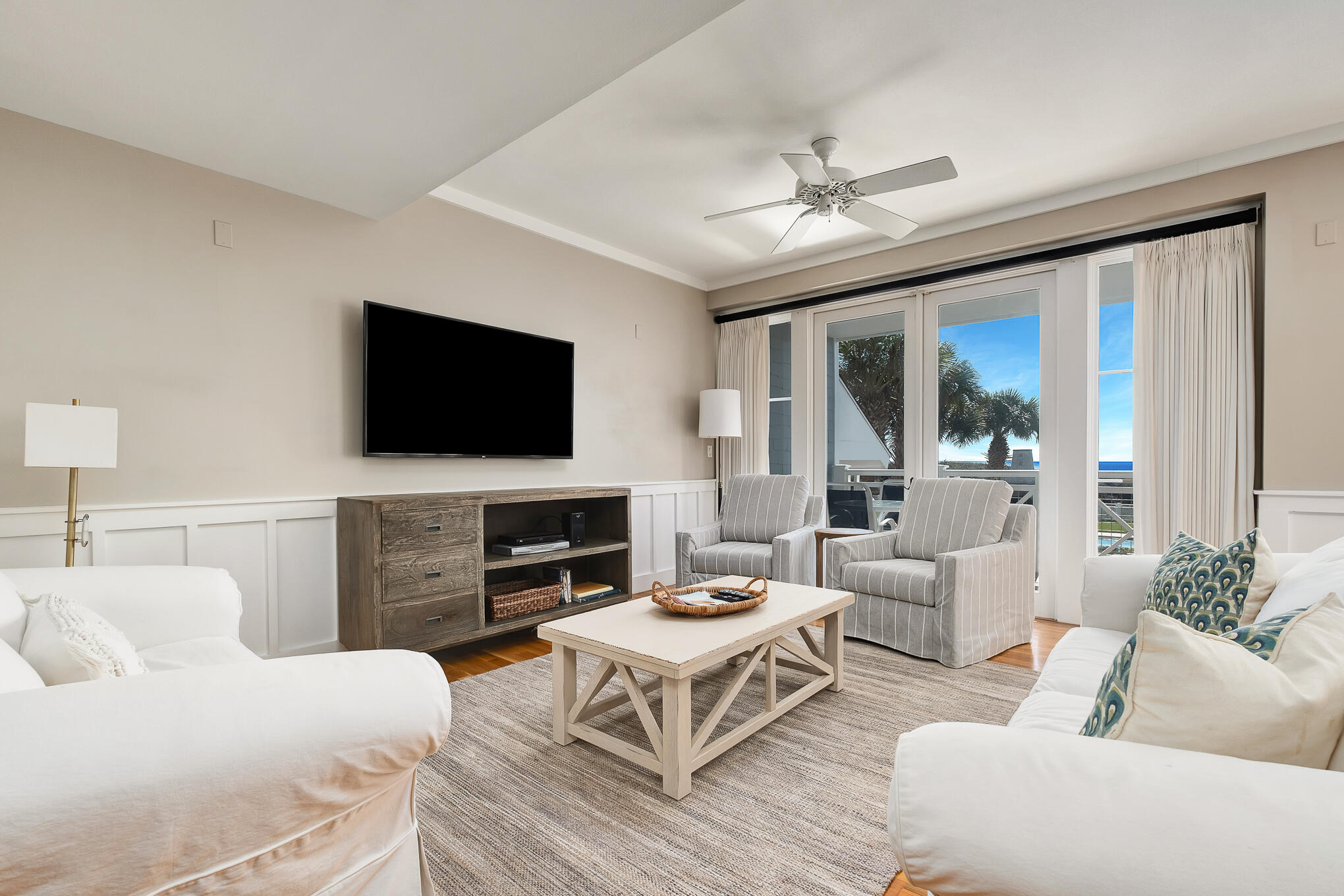337 Bridge Lane, Unit 103B Inlet Beach, FL 32461 - Photo 2 of 37 a living room with furniture a flat screen tv and a large window