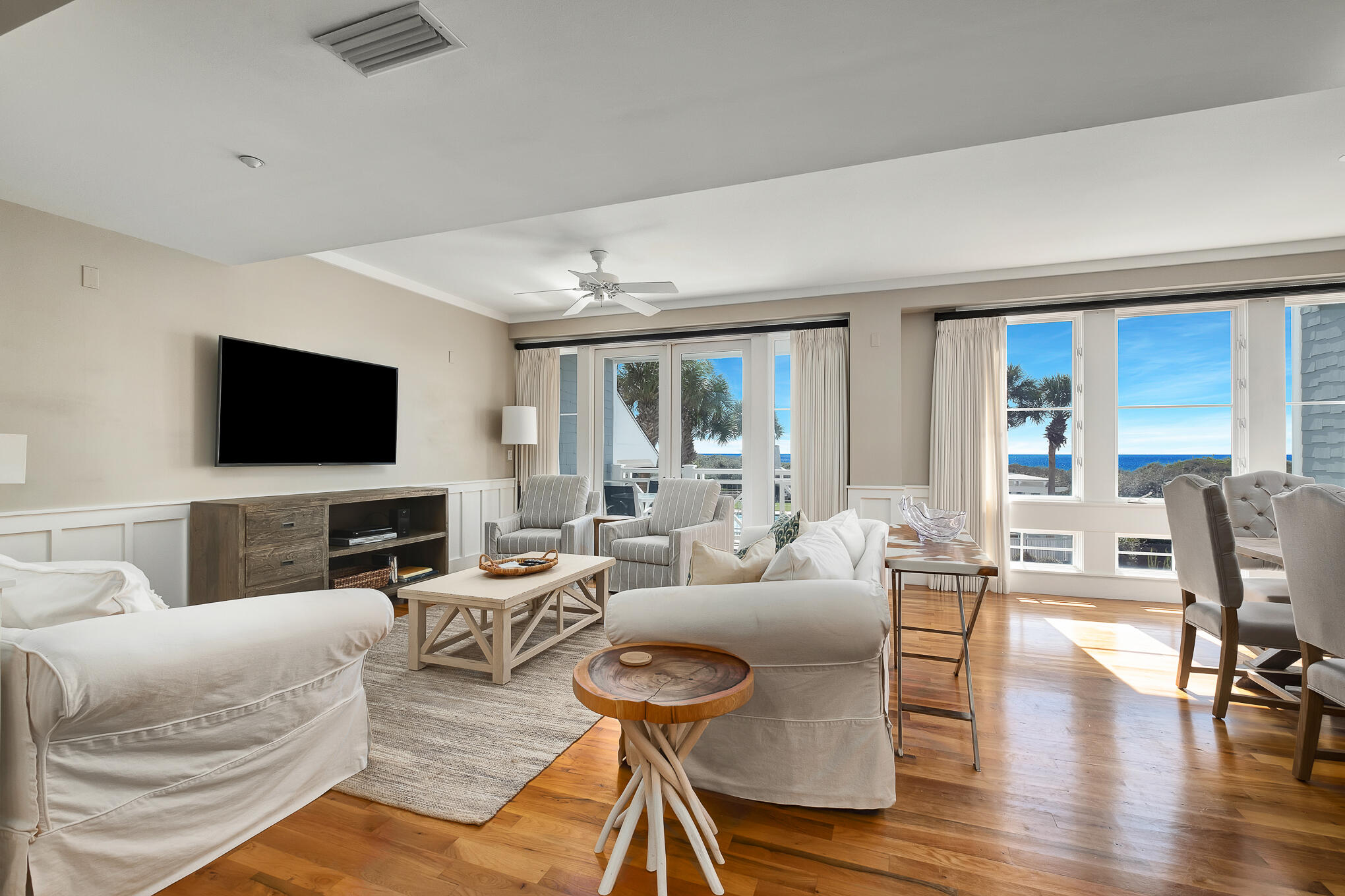 337 Bridge Lane, Unit 103B Inlet Beach, FL 32461 - Photo 3 of 37 a living room with furniture a flat screen tv and a large window