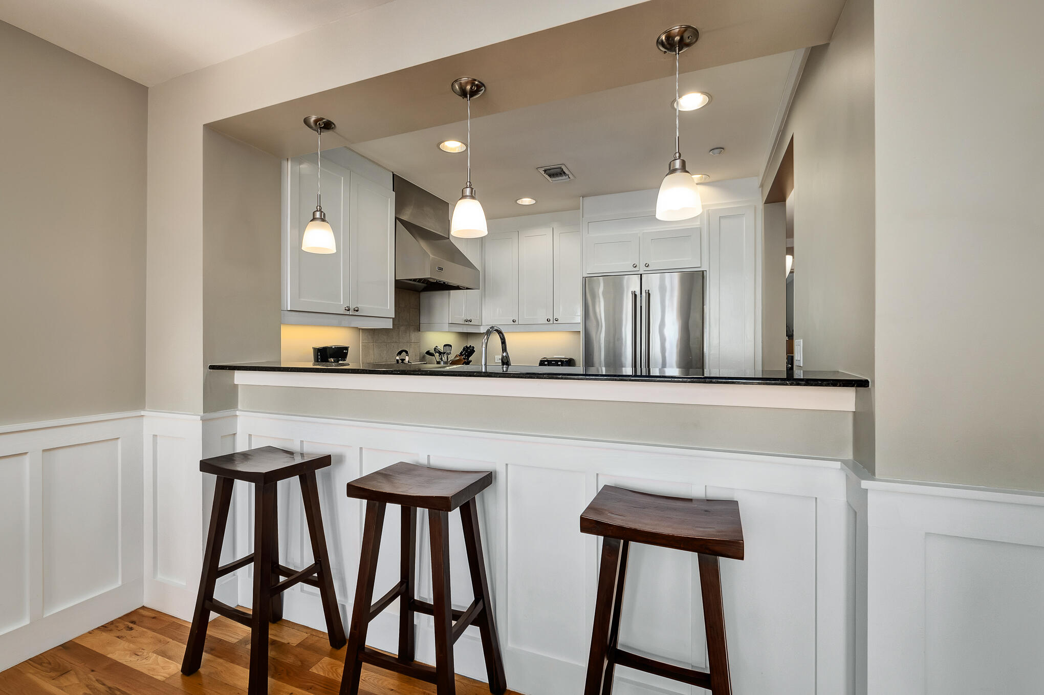 337 Bridge Lane, Unit 103B Inlet Beach, FL 32461 - Photo 9 of 37 a kitchen with stainless steel appliances a table and chairs in it