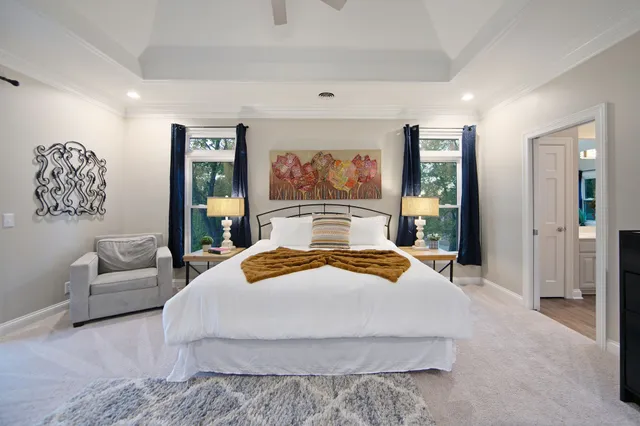 a bedroom with a large bed and a couch