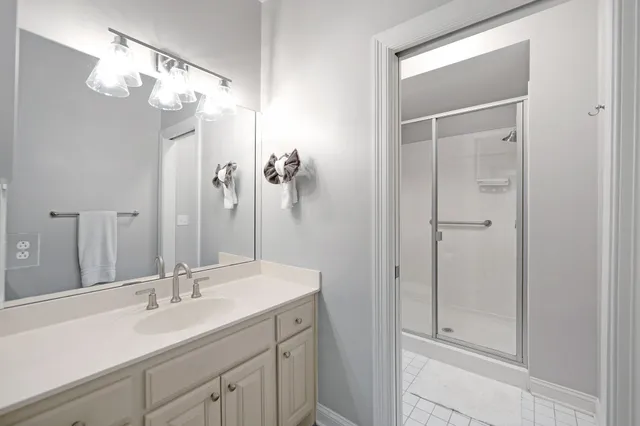a bathroom with a shower sink and mirror