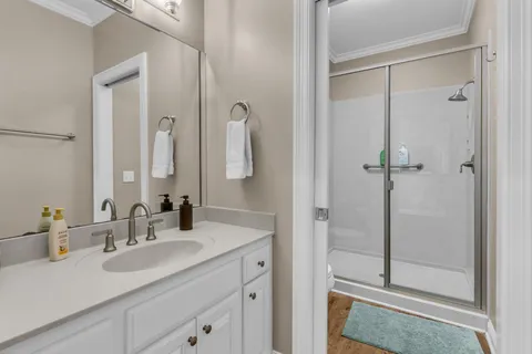 a bathroom with a shower sink and mirror