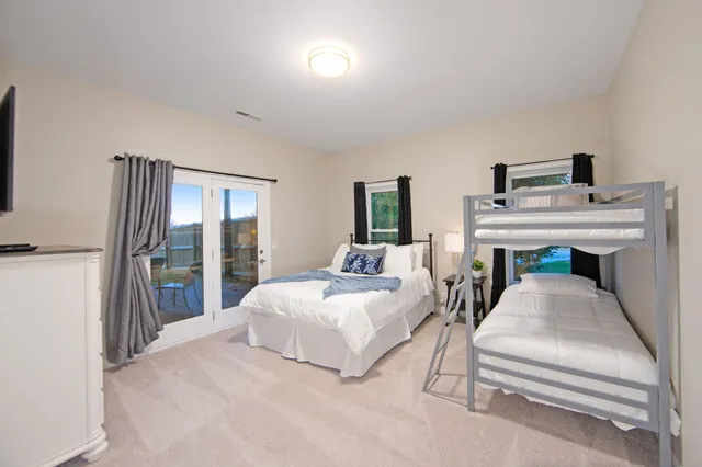 a bedroom with furniture and a flat screen tv