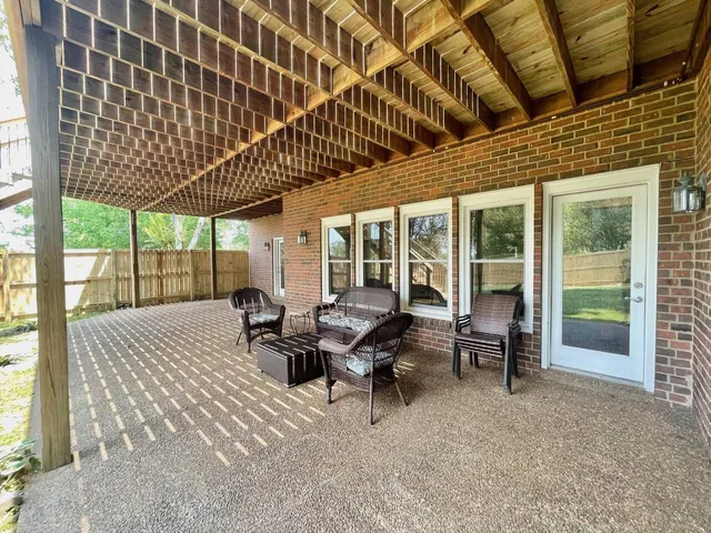 a view of a house with backyard and porch