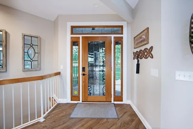 a view of a hallway with wooden floor and entryway
