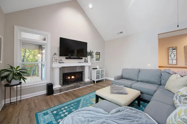 a living room with furniture a fireplace and a flat screen tv
