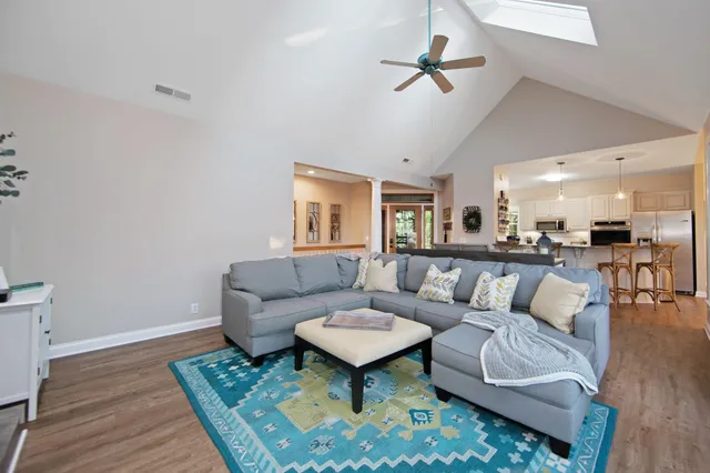 a living room with furniture a rug and a chandelier