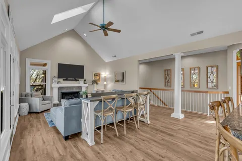 a living room with furniture and kitchen view