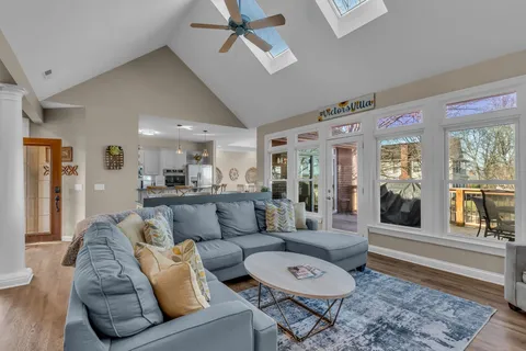 a kitchen with stainless steel appliances a refrigerator a stove a sink and chairs