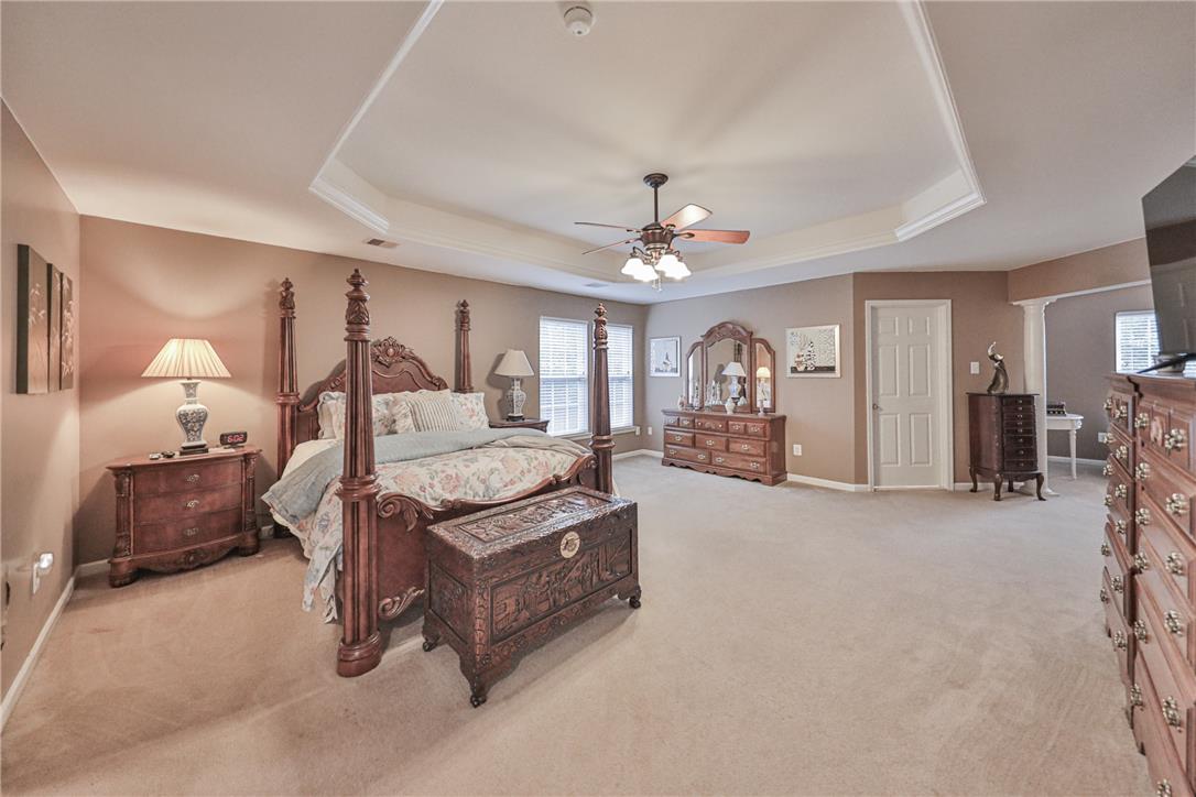 138 Clover Hollow Road Easton, PA 18045 - Photo 43 of 95 A spacious bedroom features a tray ceiling, soft carpeting, and a ceiling fan for ultimate comfort.