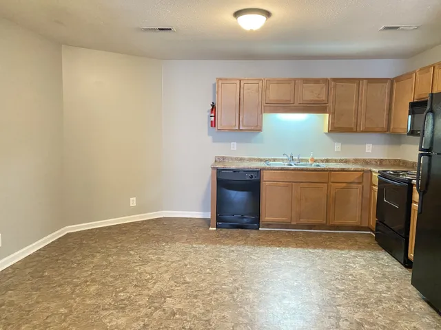 a kitchen with a sink and a stove top oven