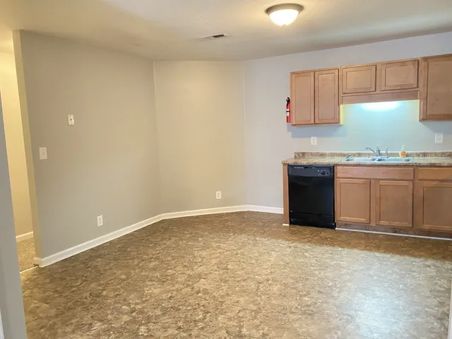a kitchen with granite countertop a sink and a stove