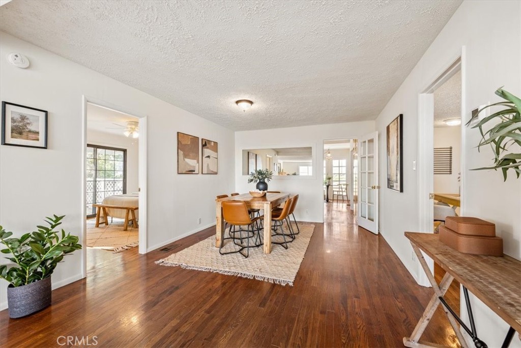 549 Derby Lane Paso Robles, CA 93446 - Photo 11 of 64 a dining room with furniture potted plants and wooden floor