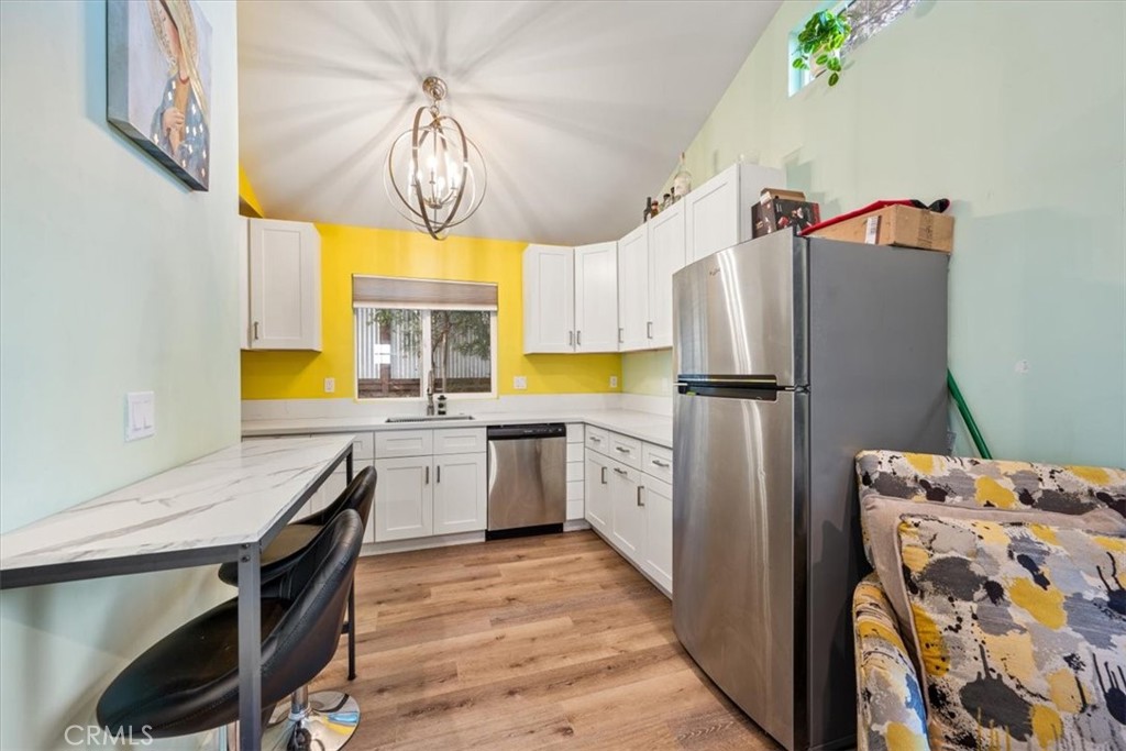 549 Derby Lane Paso Robles, CA 93446 - Photo 50 of 64 a kitchen with a refrigerator a stove a sink and a dining table