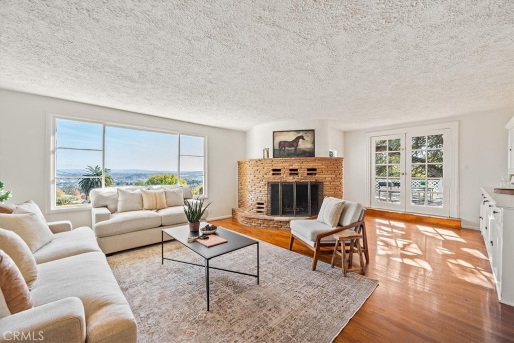 549 Derby Lane Paso Robles, CA 93446 - Photo 5 of 64 a living room with furniture a rug a fireplace and a window