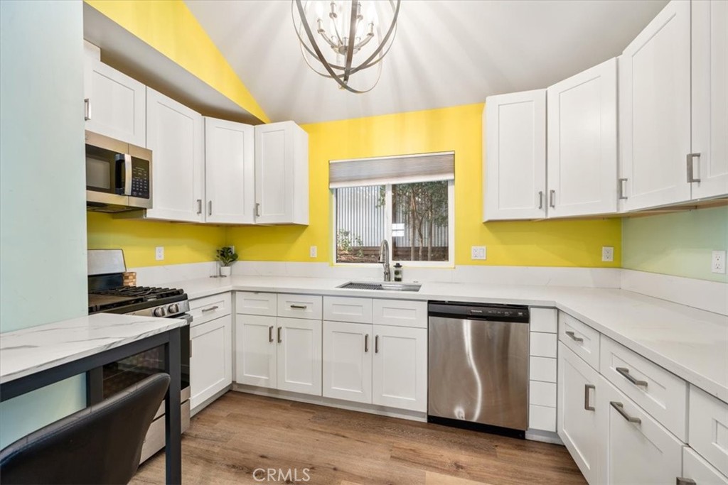 549 Derby Lane Paso Robles, CA 93446 - Photo 51 of 64 a kitchen with granite countertop white cabinets and stainless steel appliances
