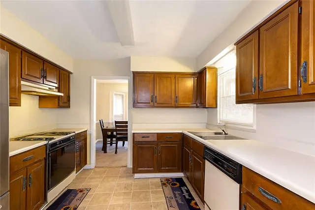a kitchen with stainless steel appliances sink stove microwave and cabinets
