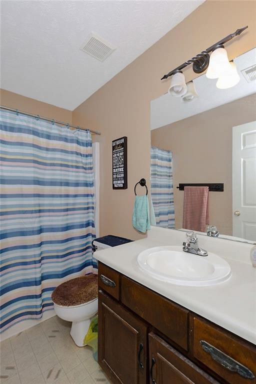 6834 Aldora Drive Columbus, GA 31907 - Photo 7 of 12 a bathroom with a sink a toilet and mirror
