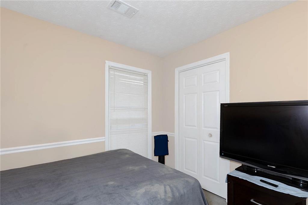 6834 Aldora Drive Columbus, GA 31907 - Photo 8 of 12 a bedroom with a bed and a flat screen tv