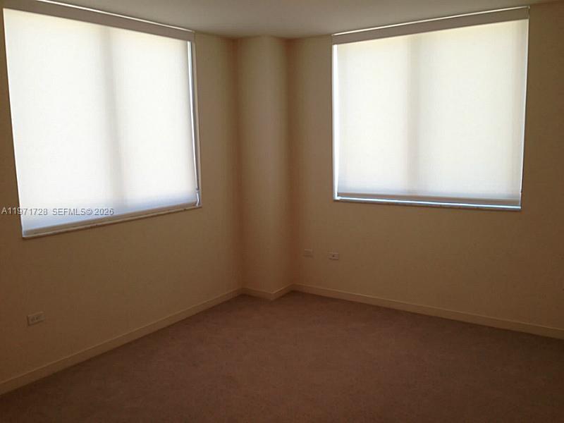 999 Southwest 1st Avenue, Unit 1803 Miami, FL 33130 - Photo 5 of 13 an empty room with a window