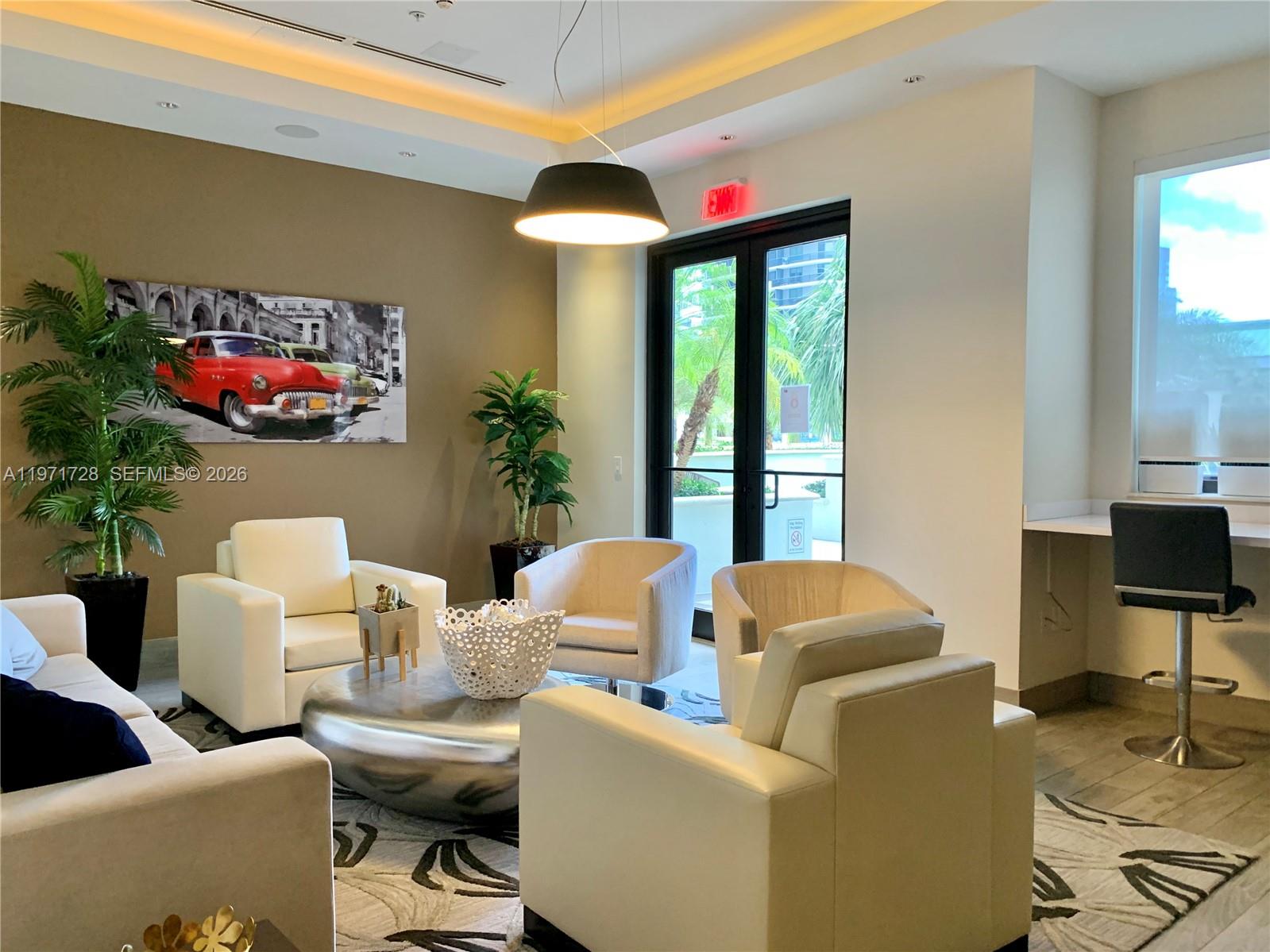 999 Southwest 1st Avenue, Unit 1803 Miami, FL 33130 - Photo 10 of 13 a living room with furniture and a potted plant