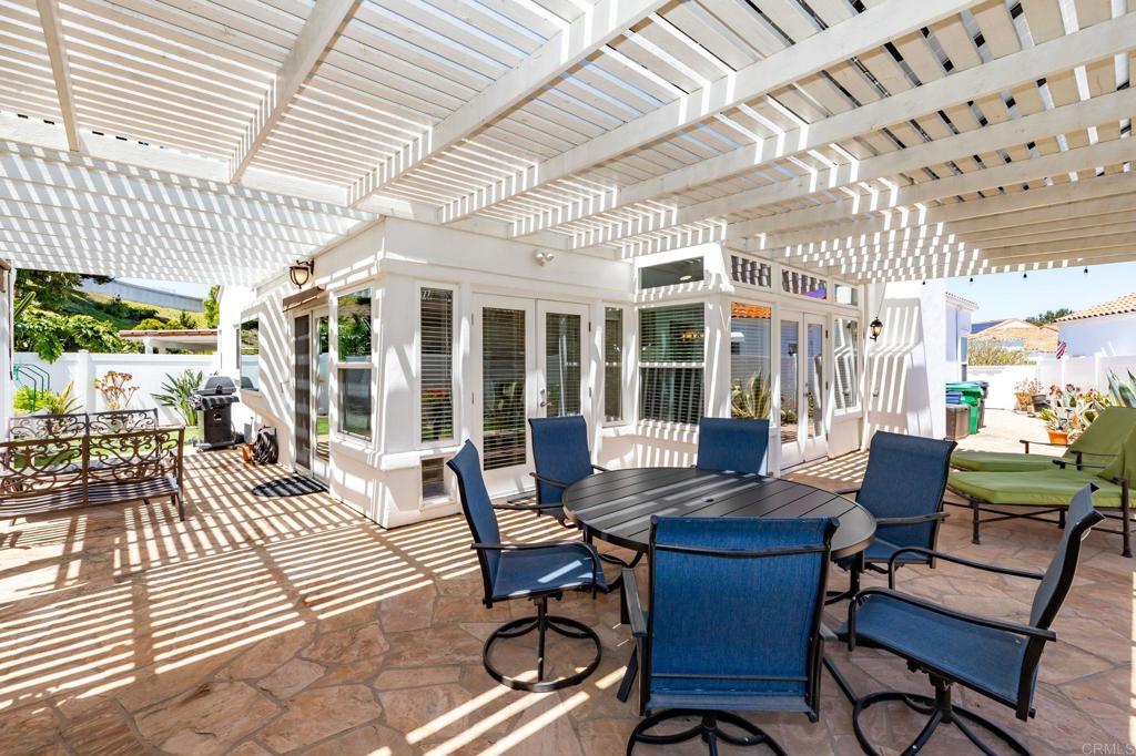 4939 Tilos Way Oceanside, CA 92056 - Photo 27 of 49 a view of a patio with table and chairs and potted plants