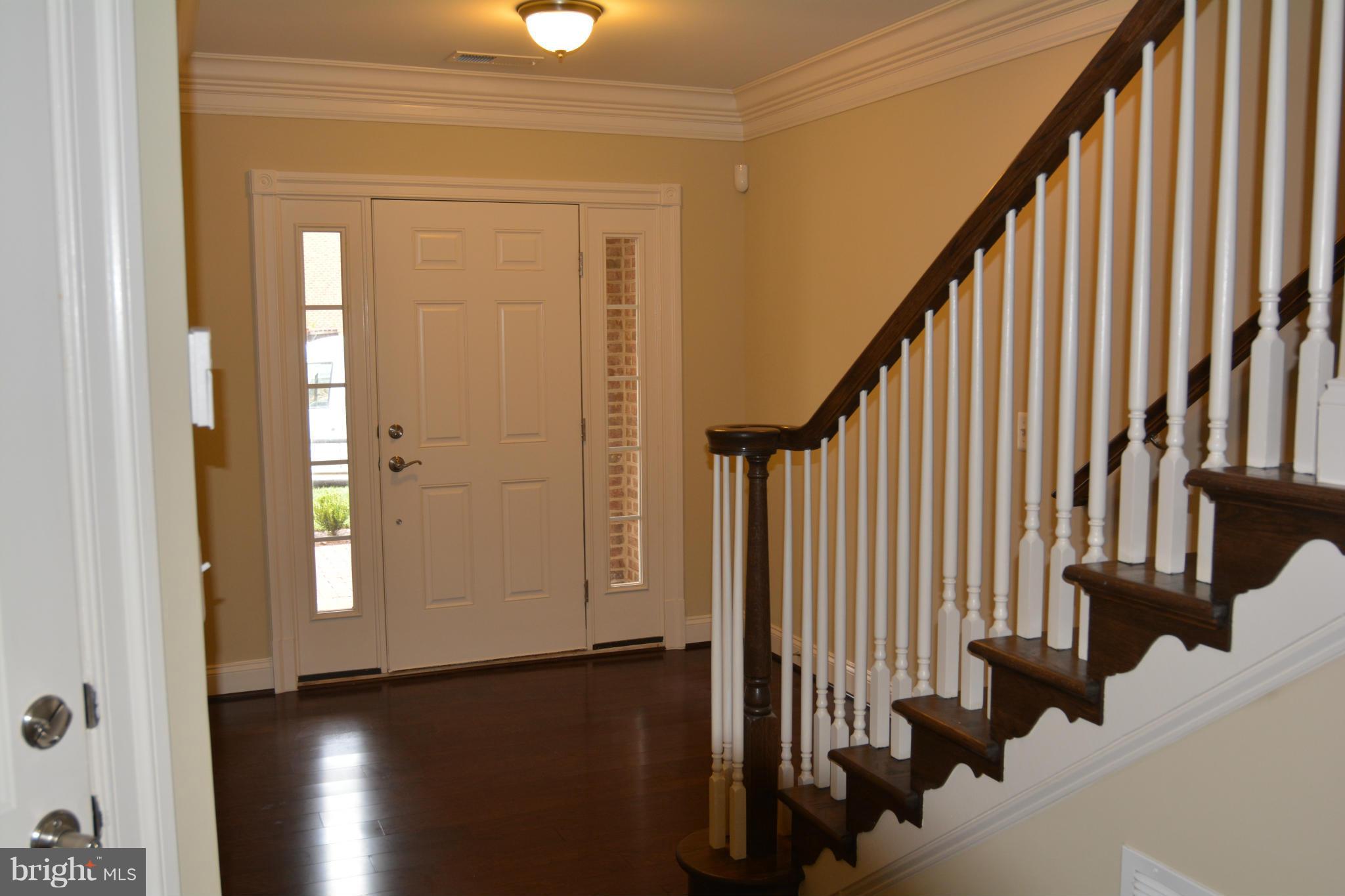 4526 Westhall Drive Washington, DC 20007 - Photo 2 of 20 a view of staircase with lots of frames on wall and a window