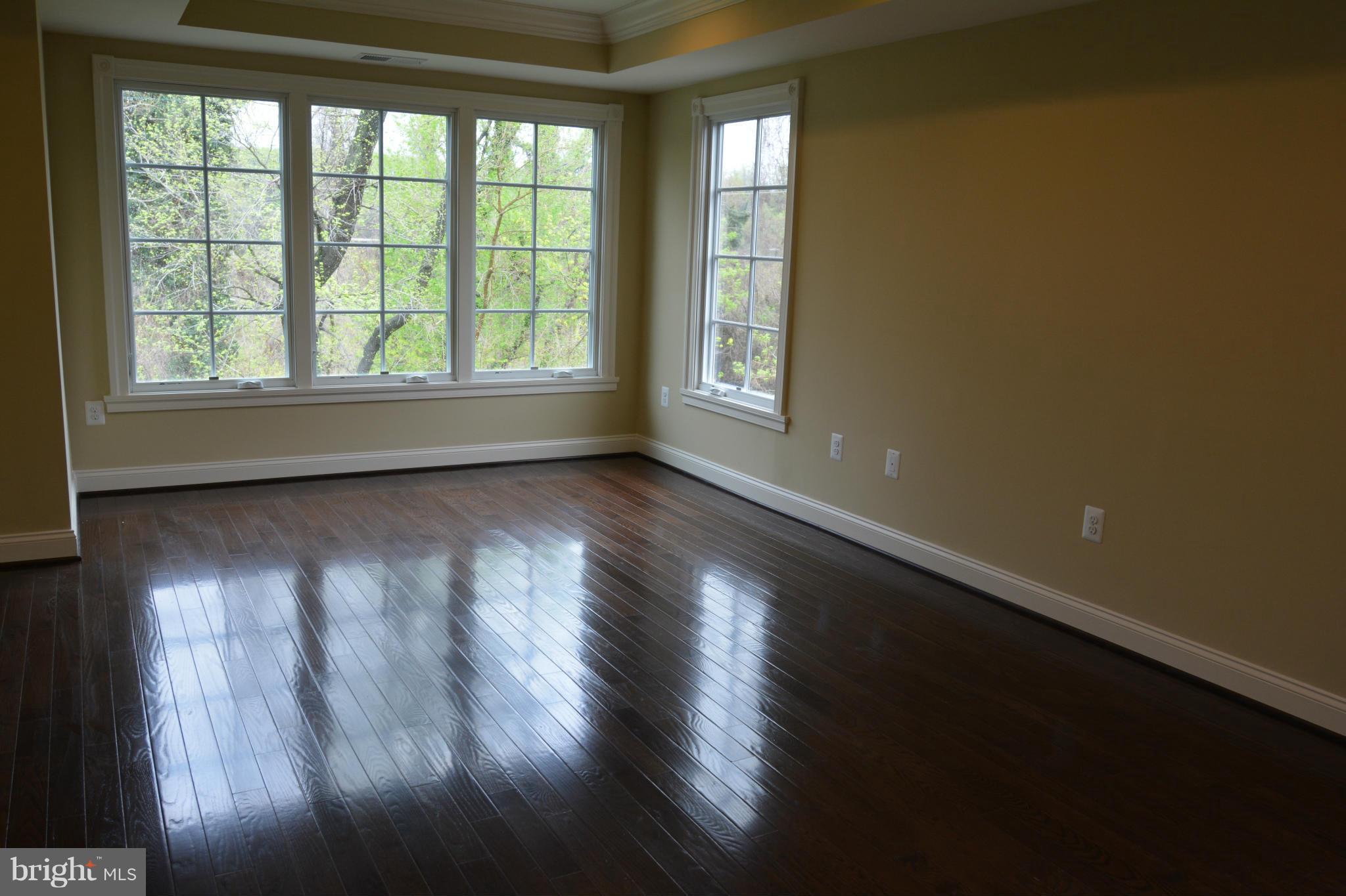 4526 Westhall Drive Washington, DC 20007 - Photo 12 of 20 a view of an empty room with wooden floor and a window