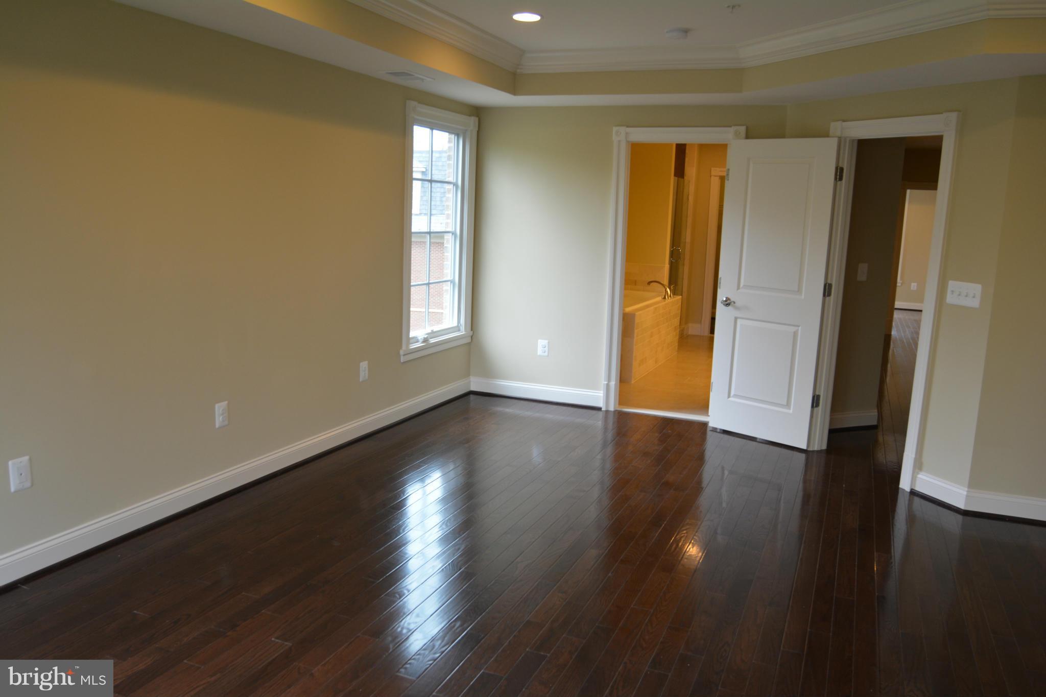 4526 Westhall Drive Washington, DC 20007 - Photo 13 of 20 an empty room with wooden floor and windows