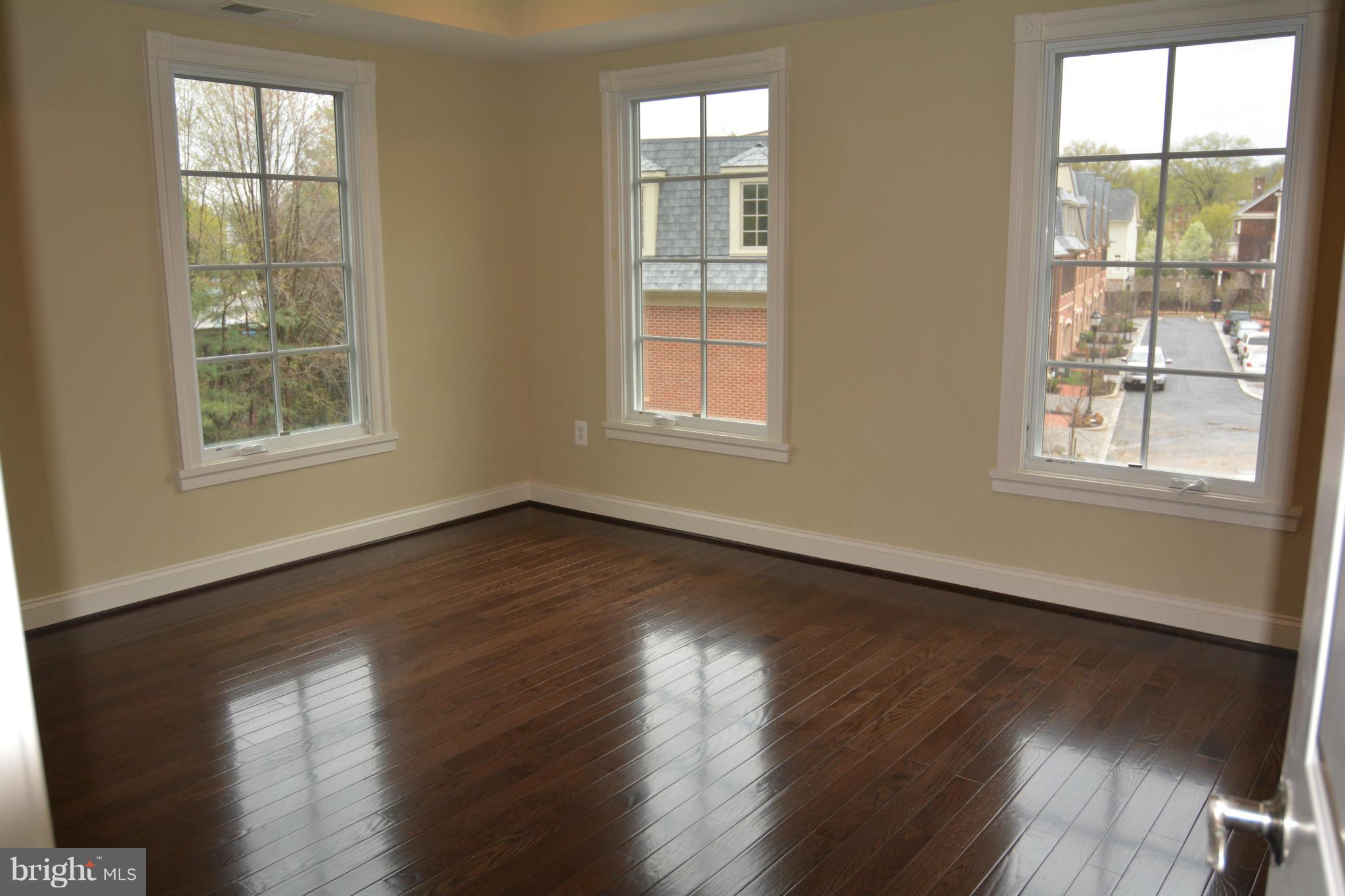4526 Westhall Drive Washington, DC 20007 - Photo 17 of 20 an empty room with wooden floor and windows