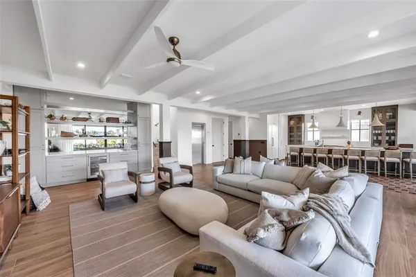 a dining room with stainless steel appliances granite countertop a sink and a table
