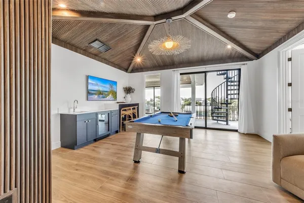 an aerial view of a house with yard and seating space