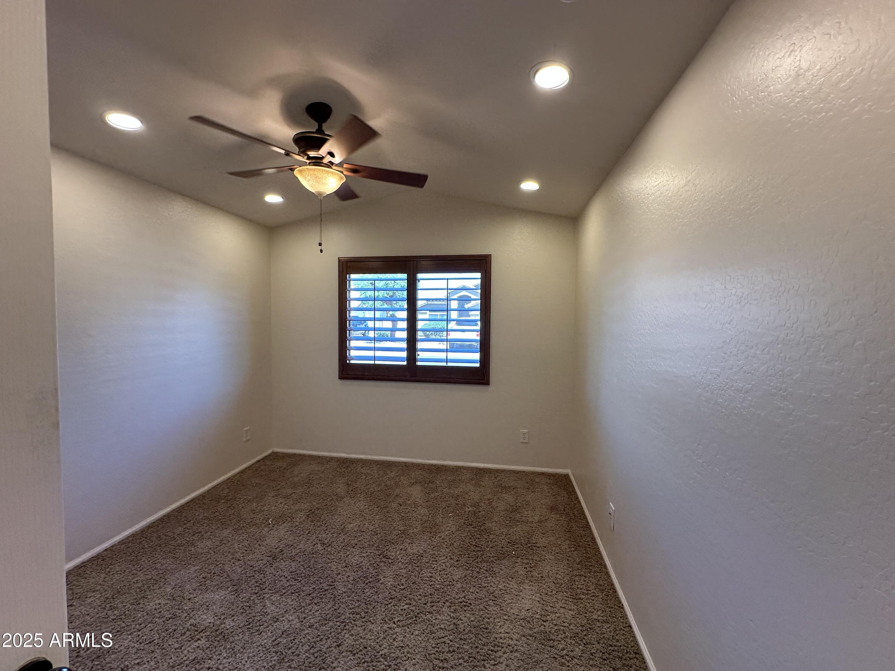 1383 East Kingman Place Casa Grande, AZ 85122 - Photo 11 of 18 an empty room with windows and fan