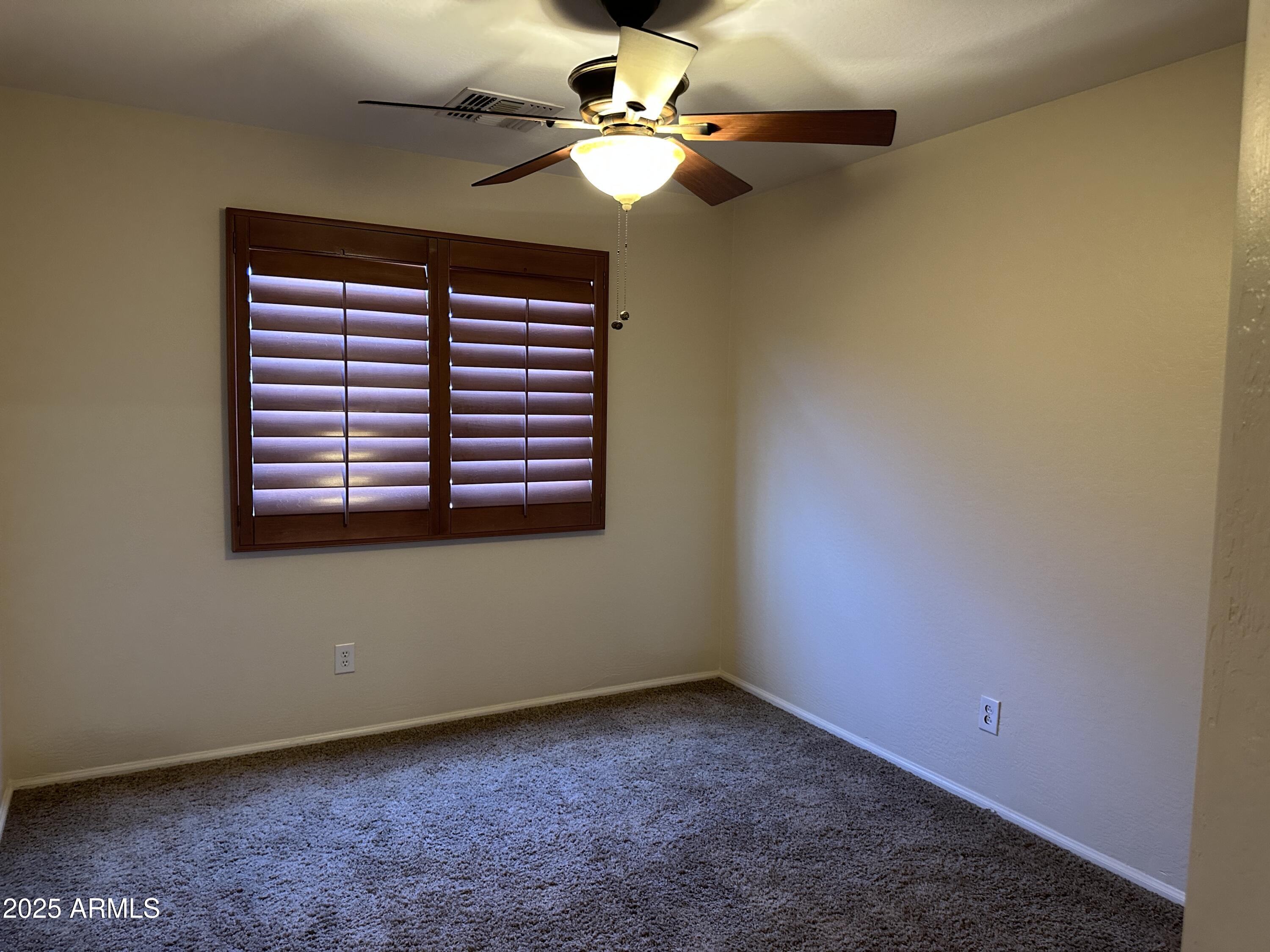 1383 East Kingman Place Casa Grande, AZ 85122 - Photo 13 of 18 a view of an empty room with a ceiling fan and a window