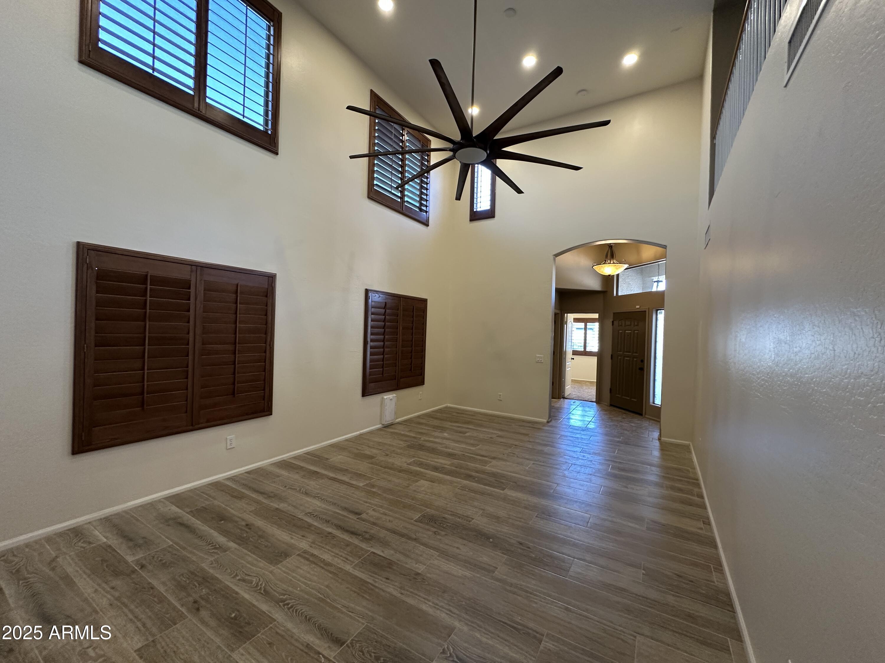 1383 East Kingman Place Casa Grande, AZ 85122 - Photo 3 of 18 a view of an empty room with window and wooden floor