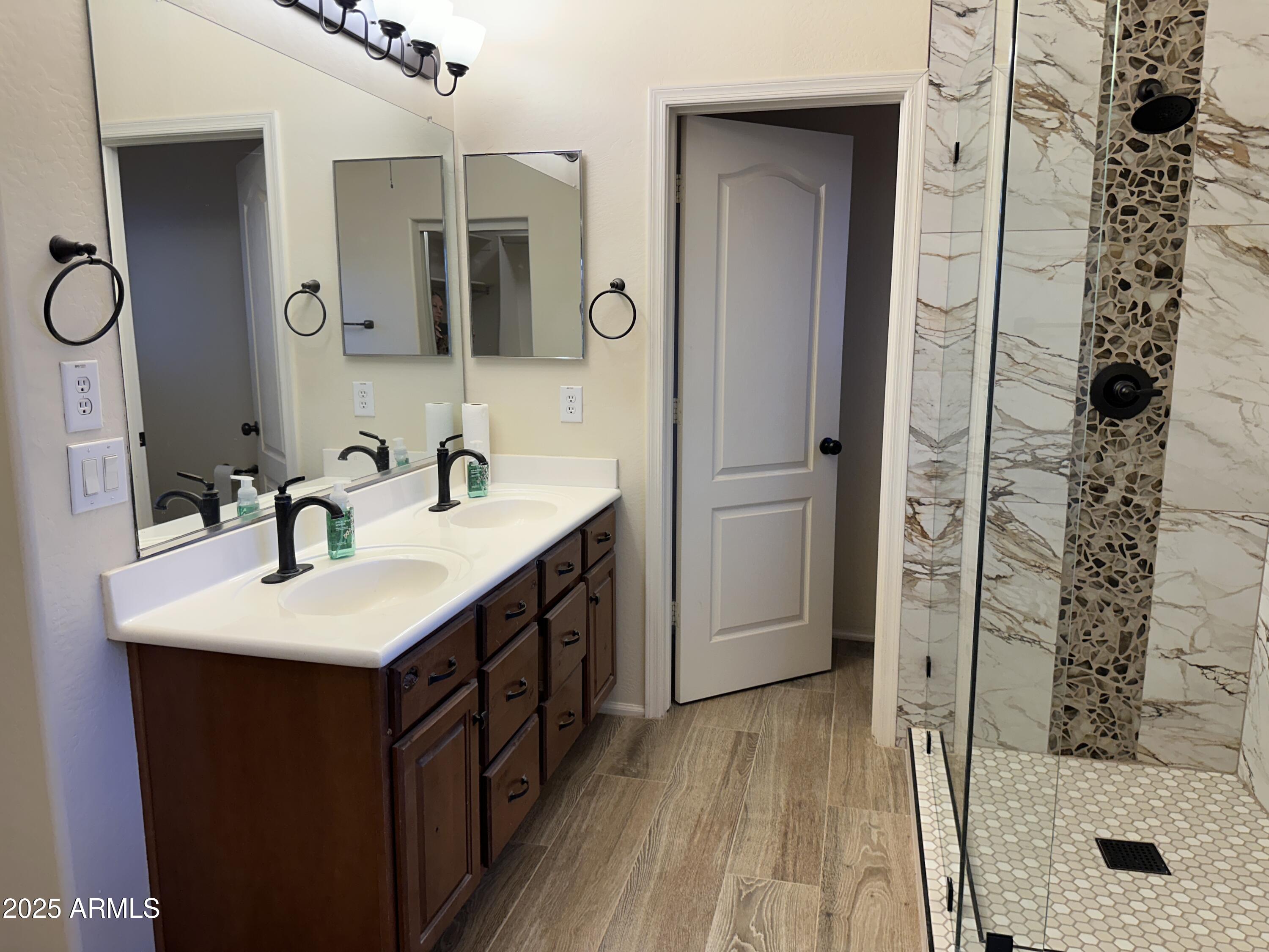 1383 East Kingman Place Casa Grande, AZ 85122 - Photo 9 of 18 a bathroom with a sink a mirror and shower