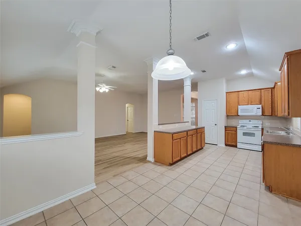 a large kitchen with stainless steel appliances granite countertop a sink and cabinets