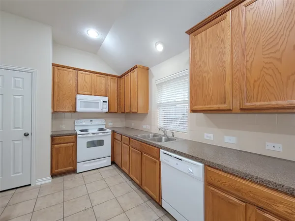 a kitchen with a stove a sink and a refrigerator