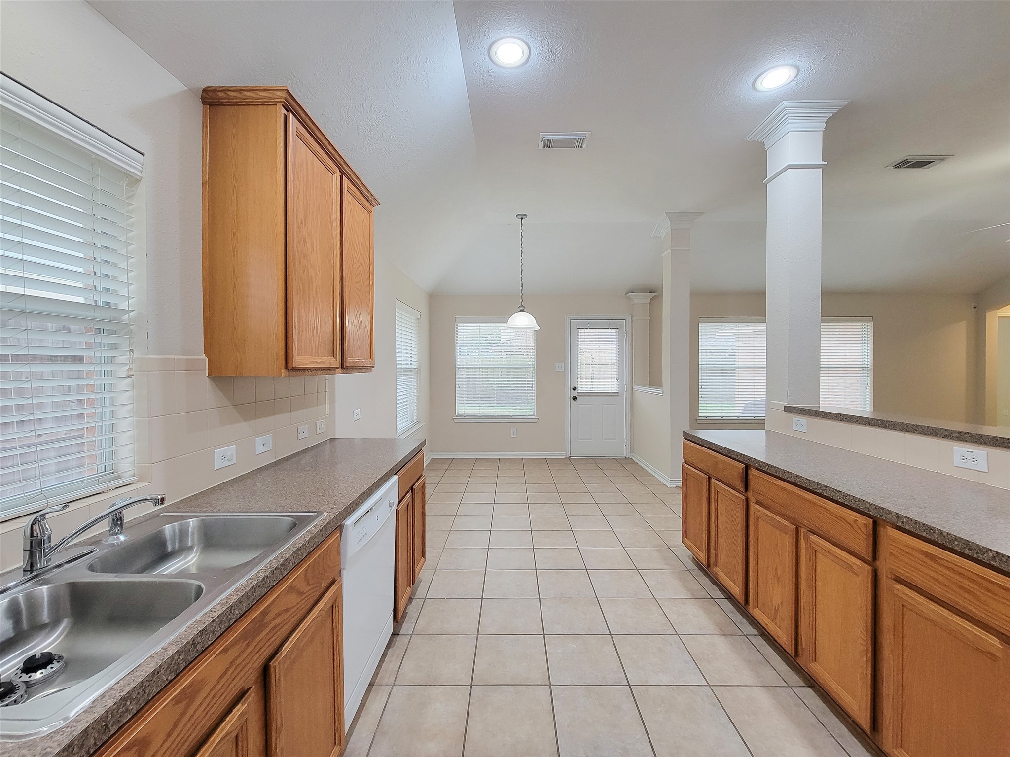 6806 Haley Court Pearland, TX 77584 - Photo 22 of 38 a large kitchen with granite countertop a sink a counter space and cabinets