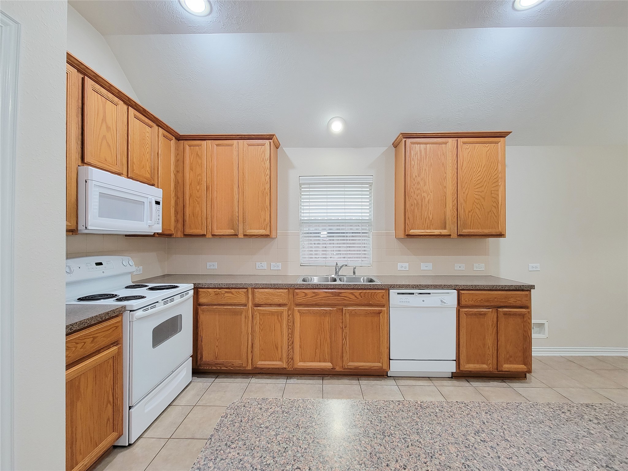 6806 Haley Court Pearland, TX 77584 - Photo 24 of 38 a kitchen with stainless steel appliances granite countertop wooden cabinets a sink and dishwasher