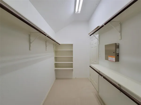 an empty room with a window and a mirror