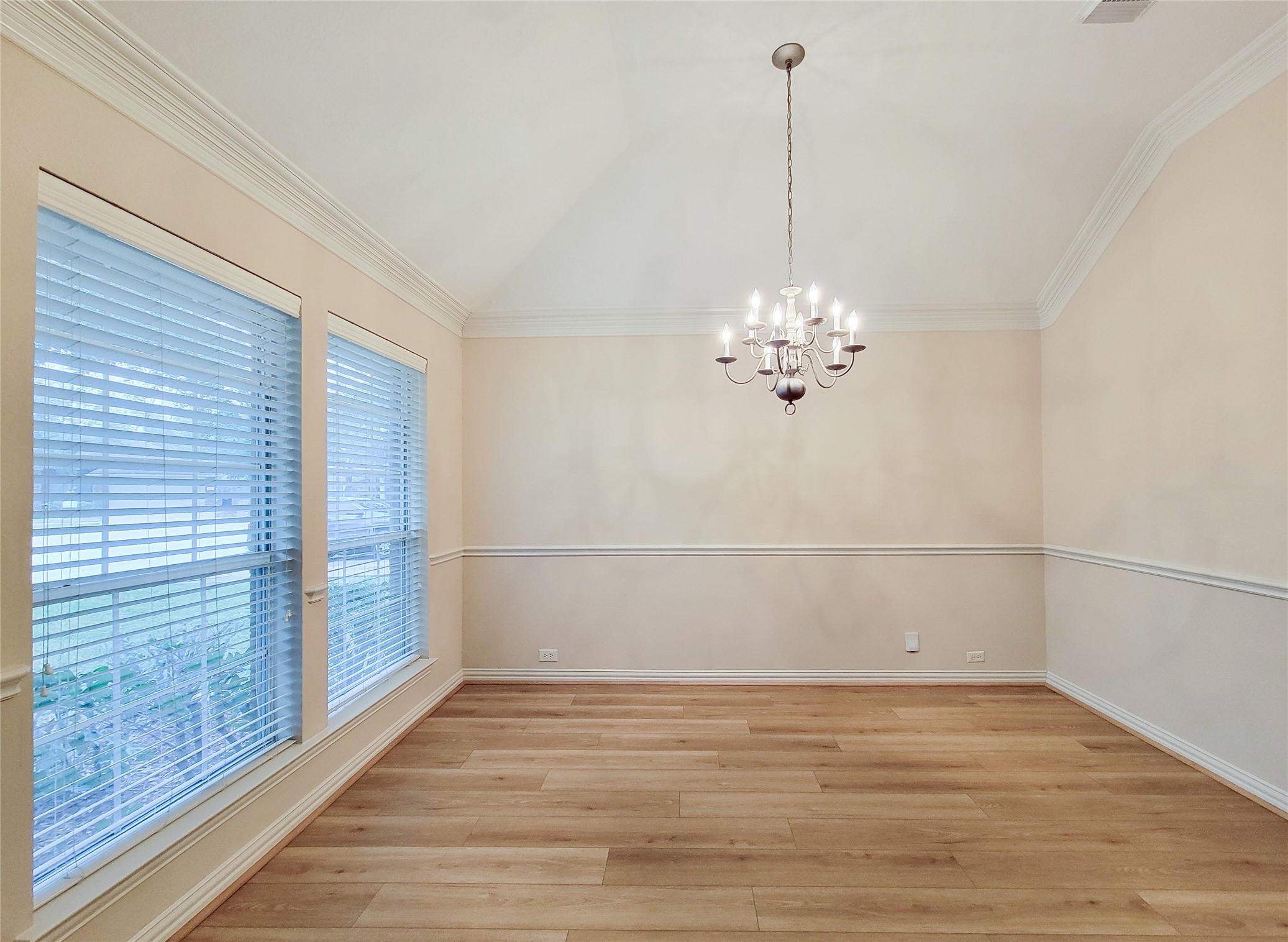 6806 Haley Court Pearland, TX 77584 - Photo 5 of 38 a view of a room with a chandelier fan and wooden floor