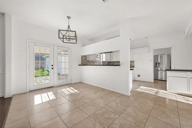 a kitchen with stainless steel appliances and white cabinets