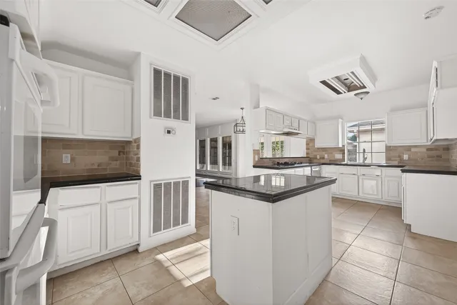 a kitchen with stainless steel appliances granite countertop a sink and cabinets