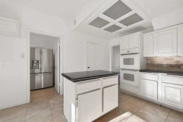 a bathroom with a toilet a sink a mirror and vanity